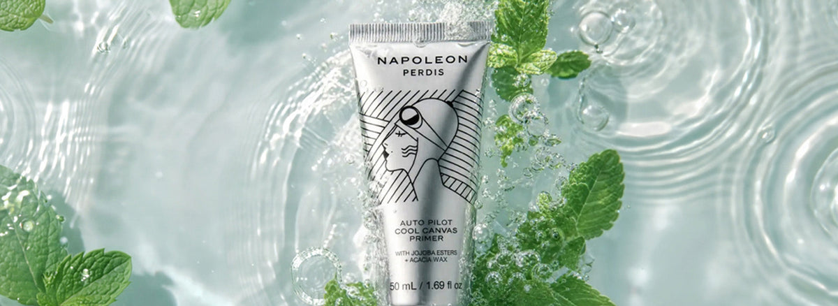 Auto Pilot Cool Canvas Primer tube resting on rippling water surrounded by fresh green leaves